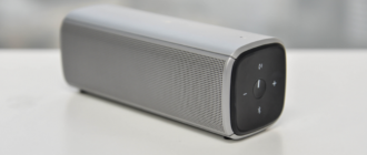 gray bluetooth speaker on a table