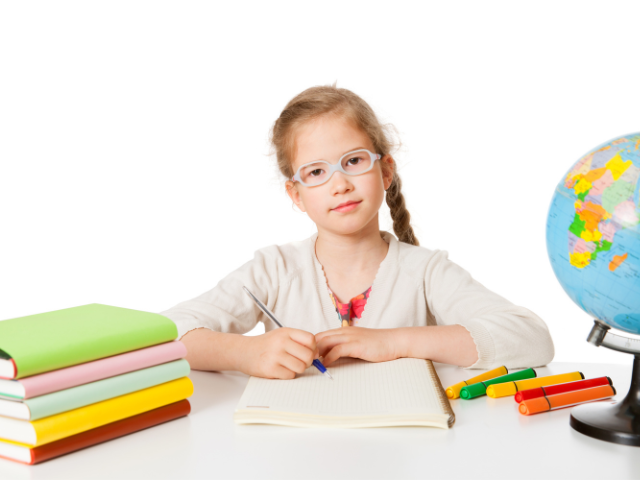 1st grader with books on table