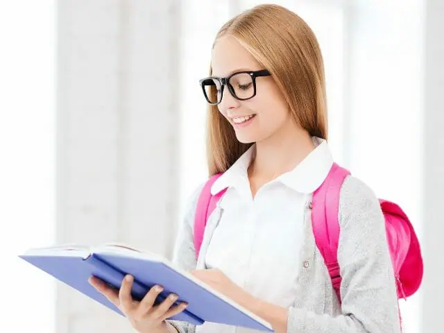 girl student smiling with eyeglasses reading book