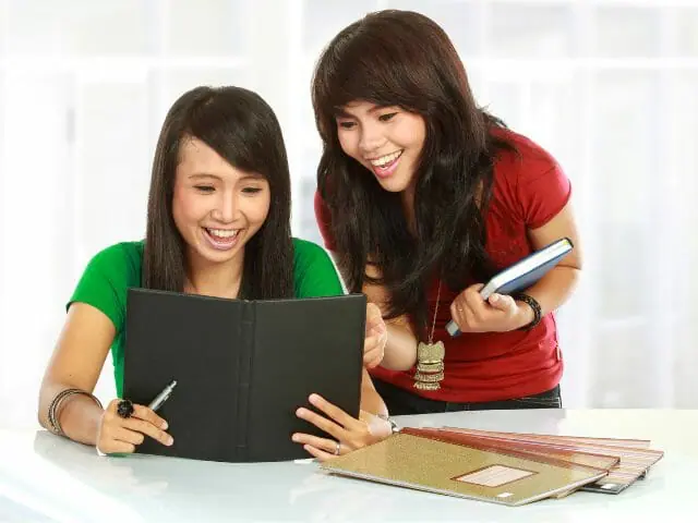 students smiling reading book