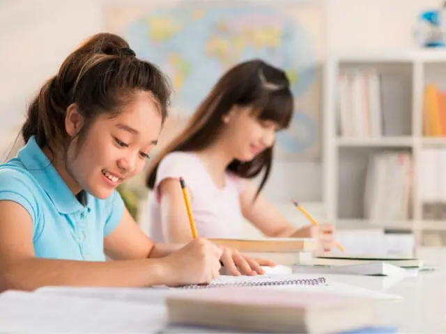 students writing class using pencil